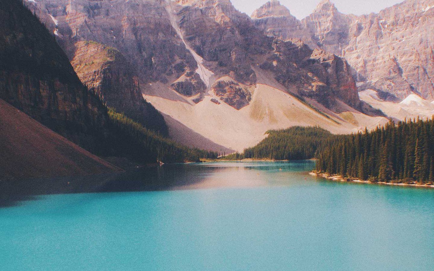 blue body of water beneath a mountain range